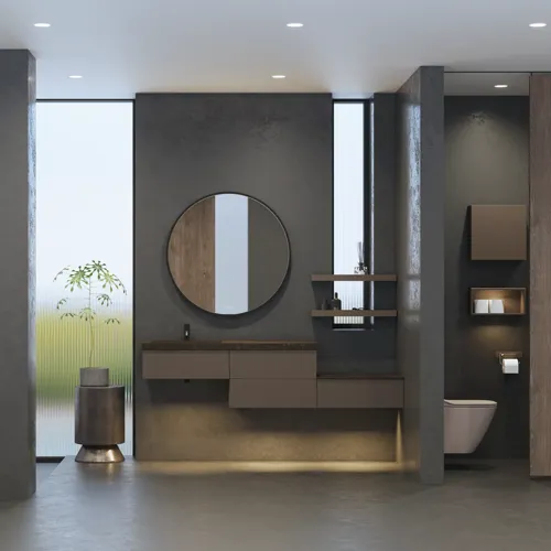 Stijlvolle en ruime badkamer inspiratie met grote ronde spiegel met zwarte lijst, donkere stenen wastafel, gekleurd toilet, bovenkast en open plank in een verfijnd en ingetogen ontwerp